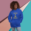 A smiling woman wearing a blue hoodie with "LOVE is the G.O.A.T." text.