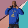 Man wearing a blue hoodie with gold text on a colorful background.