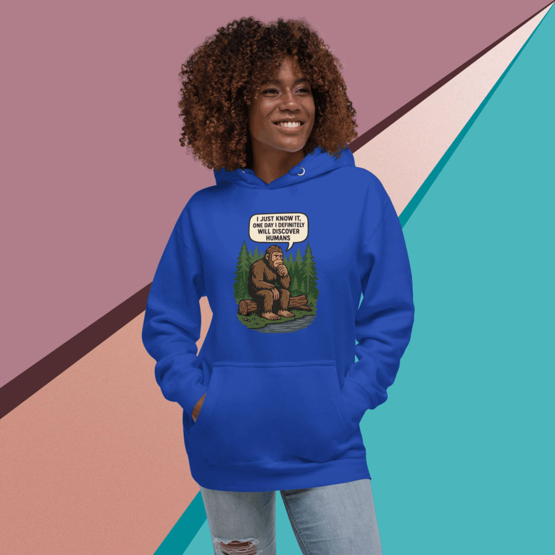 A smiling woman in a blue hoodie stands against a colorful geometric background.
