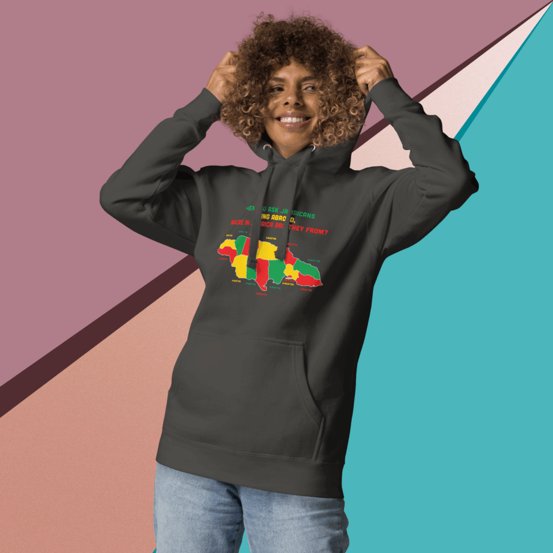 Smiling young woman wearing a dark hoodie with a colorful graphic, posing playfully.