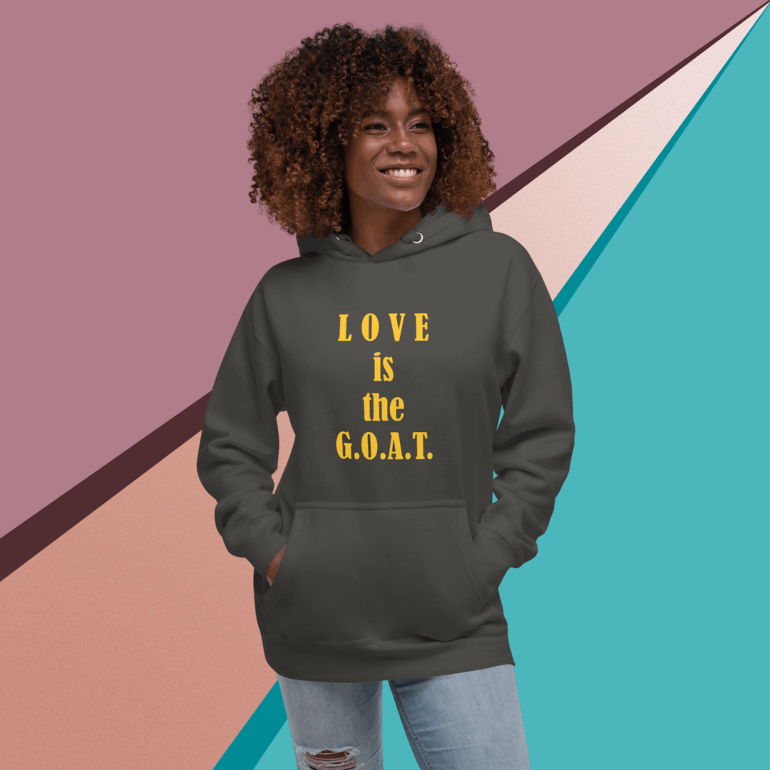 Woman wearing a dark hoodie with 'LOVE is the G.O.A.T.' text.