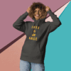 Woman wearing a dark hoodie with "Love is Real" text.