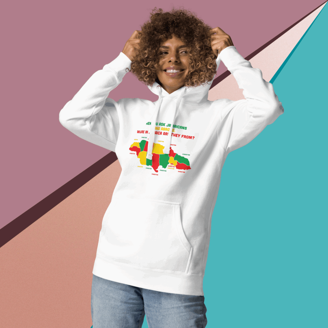 Smiling person in a white hoodie with colorful map design.