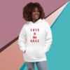 Smiling woman wearing a white hoodie with 'LOVE is G.O.L.D.' text.