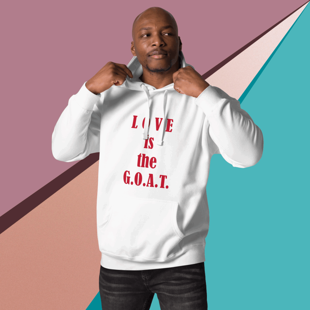 Man wearing a white hoodie with 'LOVE is the G.O.A.T.' text.