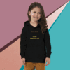 A young girl wearing a black hoodie with a positive message.