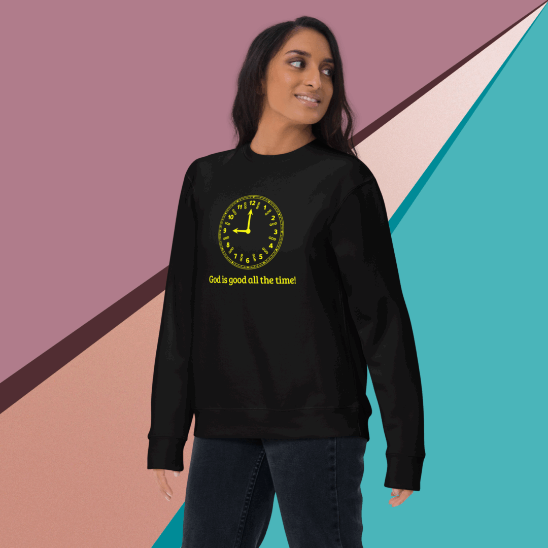 Woman wearing a black sweatshirt with a yellow smiley face and text.