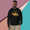 Man smiling wearing a black sweatshirt with a colorful African continent design.