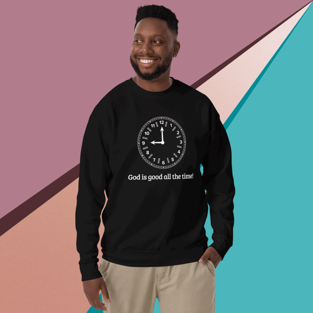 Man smiling, wearing a black sweatshirt with a clock and text design.