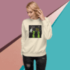 Woman wearing a cream sweatshirt with a humorous alien design.