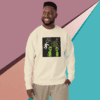 Smiling man in casual beige sweatshirt with a graphic design stands against a colorful geometric background.