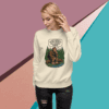Woman wearing a white sweatshirt with a nature-themed graphic design.