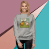 Woman wearing a grey sweatshirt with a dinosaur-themed design.