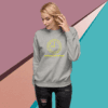 Woman in a gray sweatshirt with a yellow smiley face design.