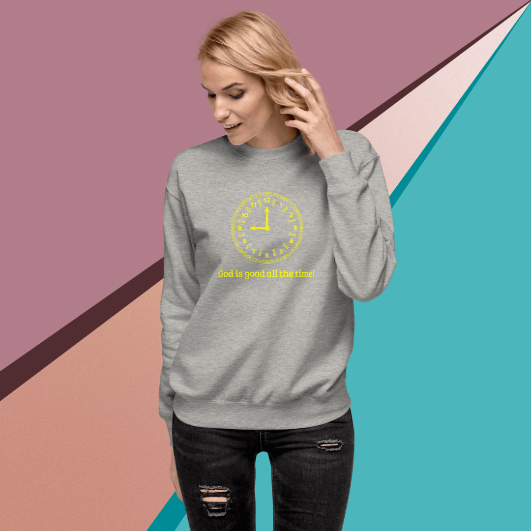 Woman in a gray sweatshirt with a yellow smiley face design.