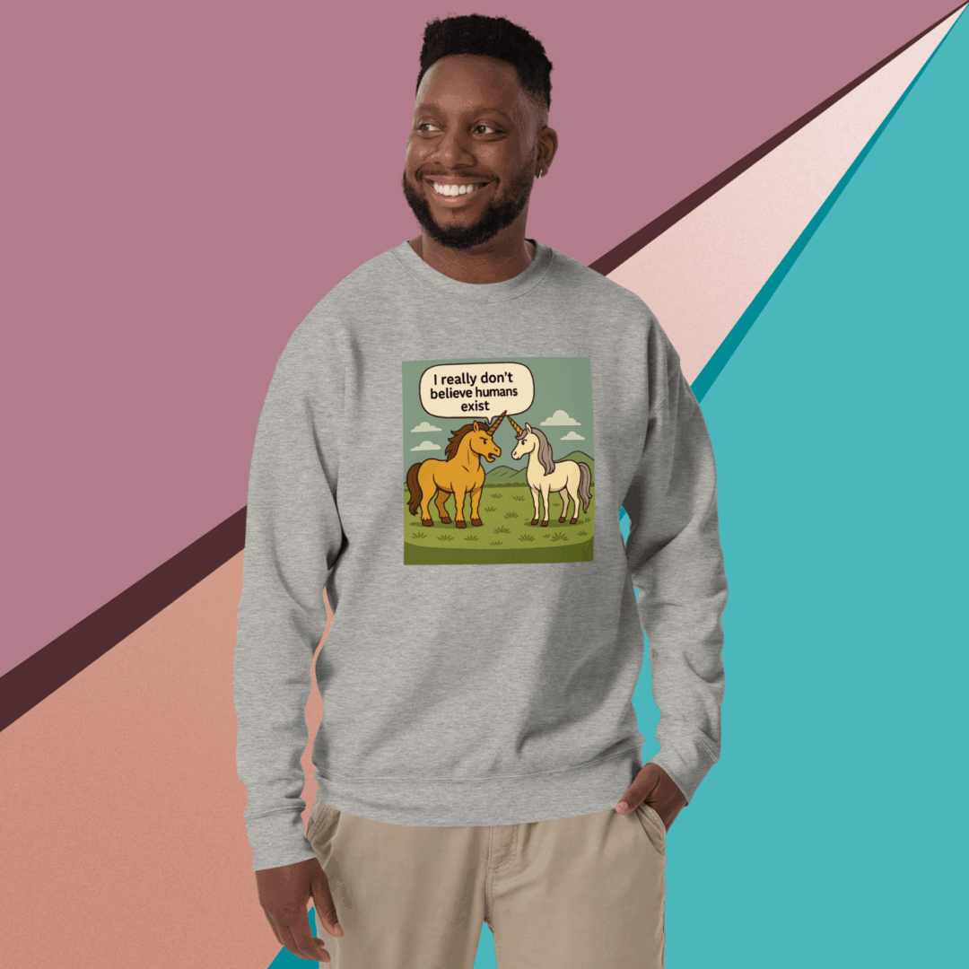 Smiling man wearing a gray sweatshirt with a colorful animal graphic design.