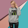 Woman wearing a gray sweatshirt with a humorous alien graphic design.