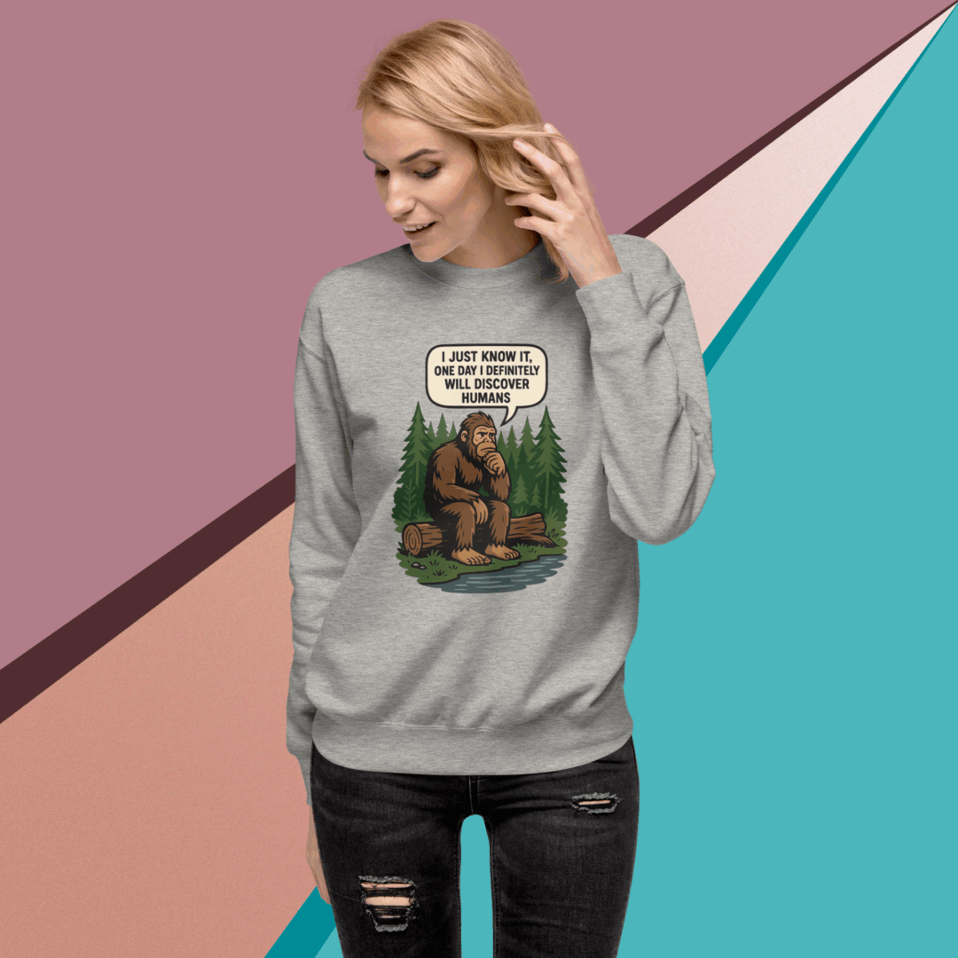 Woman wearing a gray sweatshirt with a humorous graphic design.