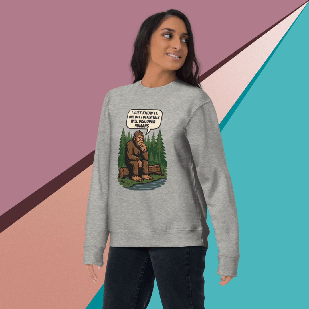 Woman wearing a gray sweatshirt with a dog graphic and text.