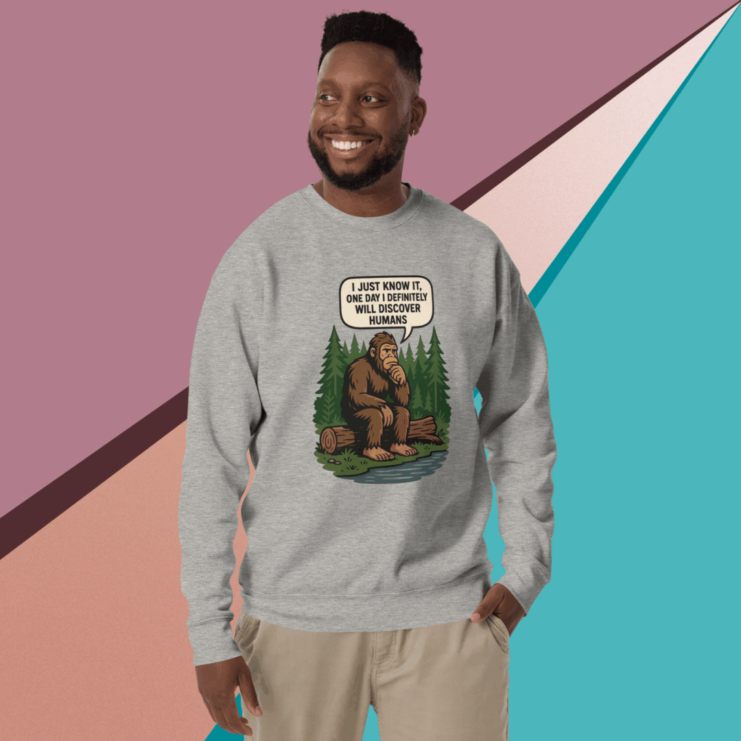 Man smiling, wearing a humorous Bigfoot sweatshirt.