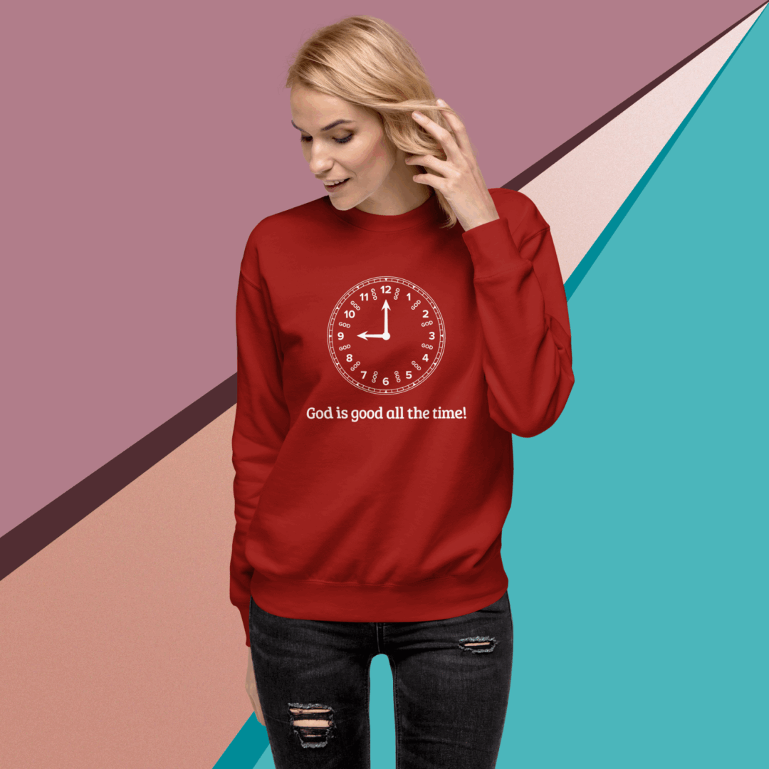 Woman wearing a red sweatshirt with a clock and text design.