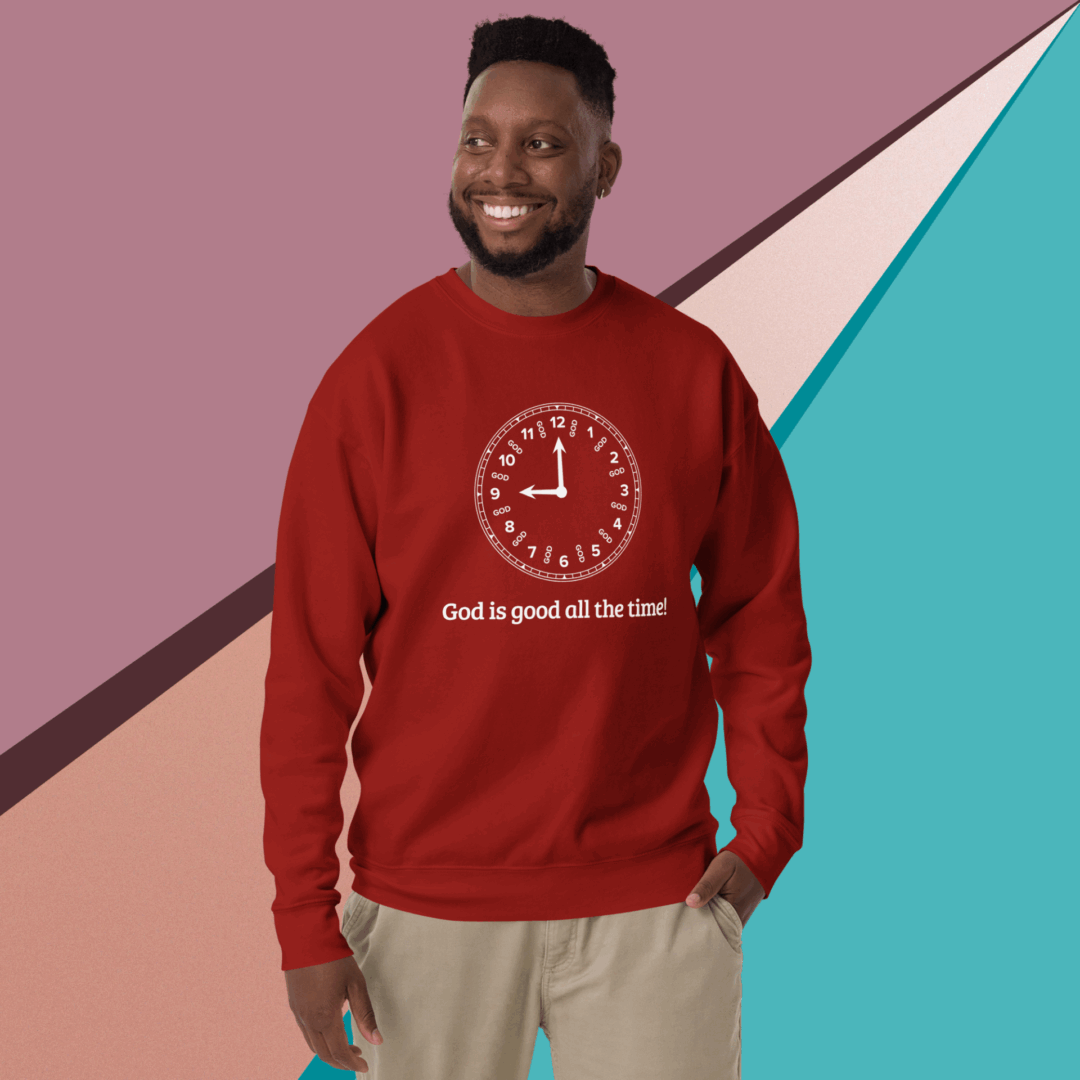 A smiling man wearing a red sweater with a positive message.