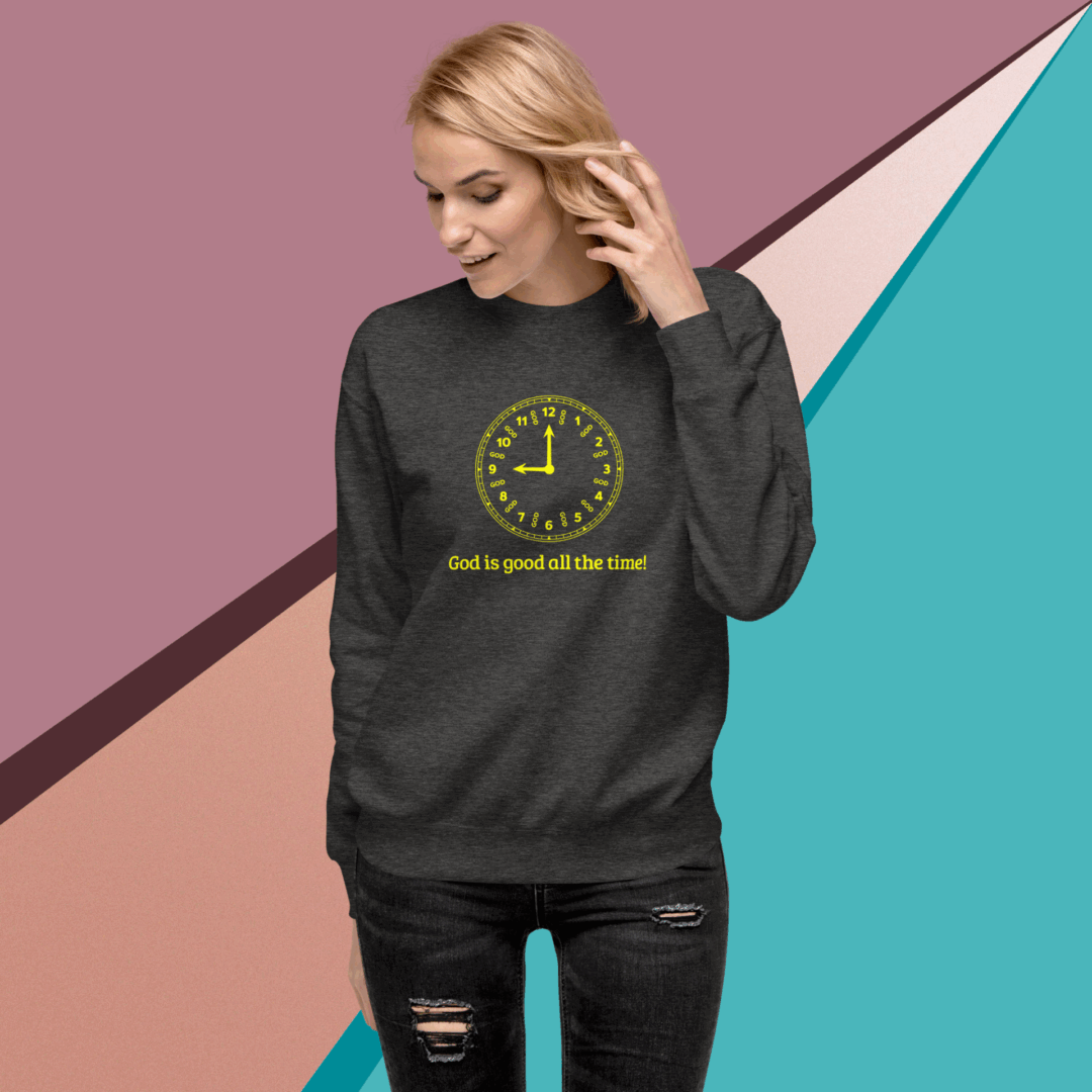 A woman wearing a dark sweatshirt with a yellow clock design and hashtag.