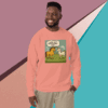 Man wearing a peach sweatshirt with a colorful dinosaur graphic design.