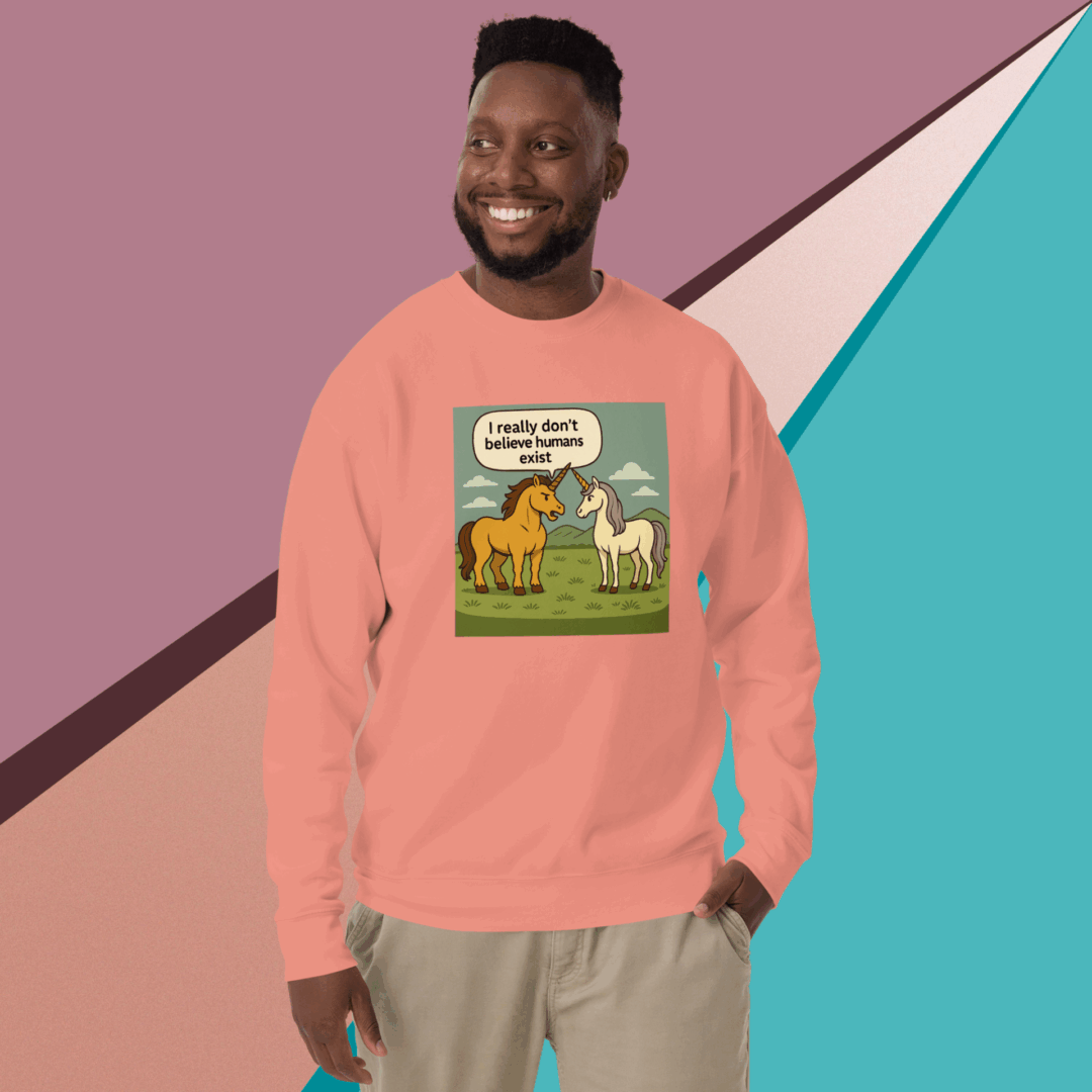 Man wearing a peach sweatshirt with a colorful dinosaur graphic design.