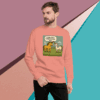 Man in peach sweatshirt with a cartoon lion and text design.