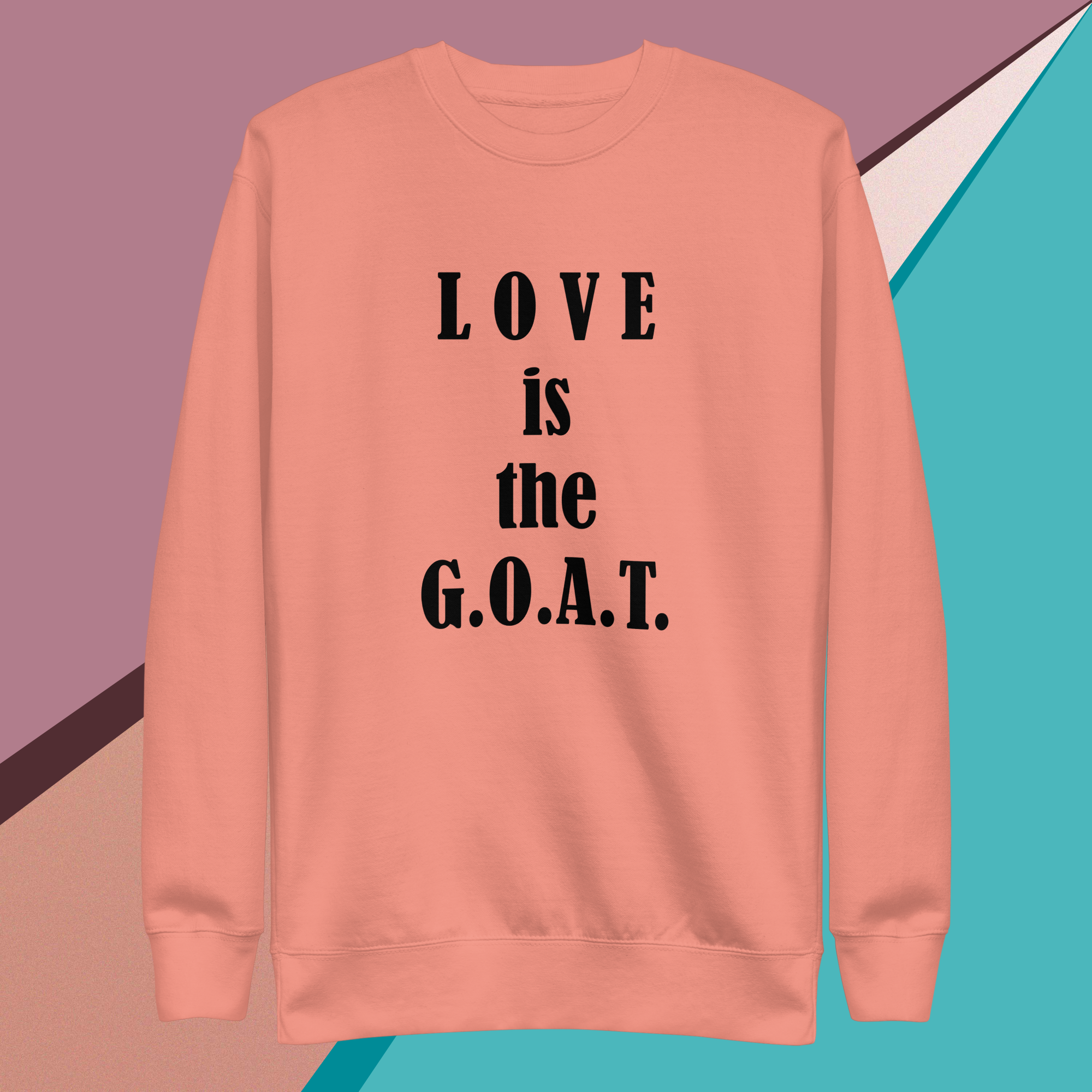 Peach sweatshirt with bold black text saying "LOVE is the G.O.A.T."