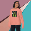 Woman wearing a peach sweatshirt with a playful alien graphic.