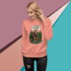 Woman wearing a peach sweatshirt with a forest-themed graphic and slogan.