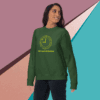 Woman wearing a green sweatshirt with a smiley face design.
