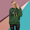 Woman wearing a green sweatshirt with an alien-themed graphic design.