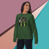 Woman wearing a green sweatshirt with an alien design and text.