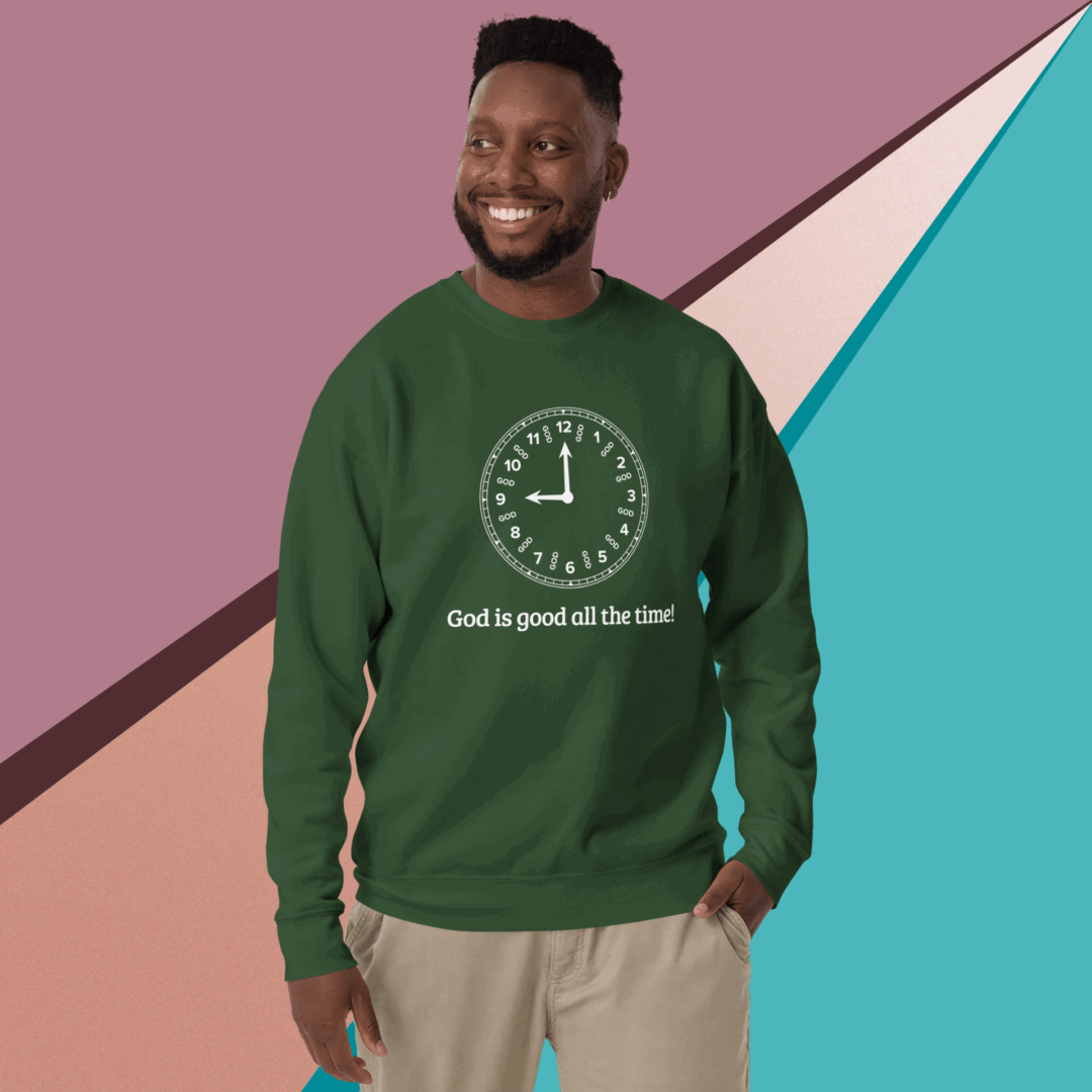 Man wearing a green sweatshirt with a positive message, smiling against a colorful geometric background.