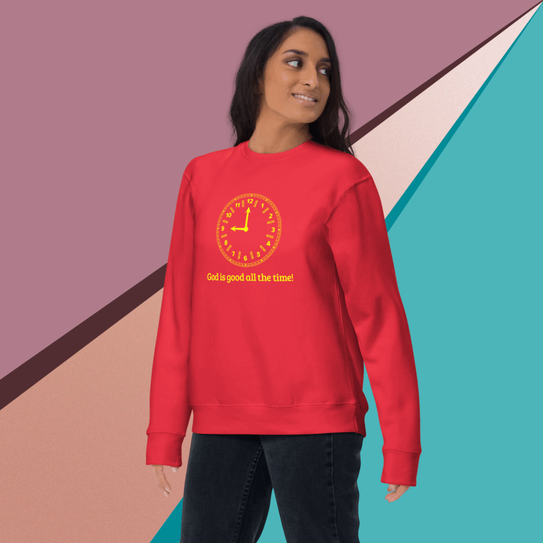 Woman in red sweatshirt with motivational text smiling confidently.