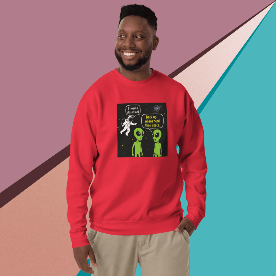 Smiling man wearing a red sweatshirt with a colorful graphic design.