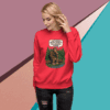 Woman wearing a red sweatshirt with a graphic design and text.