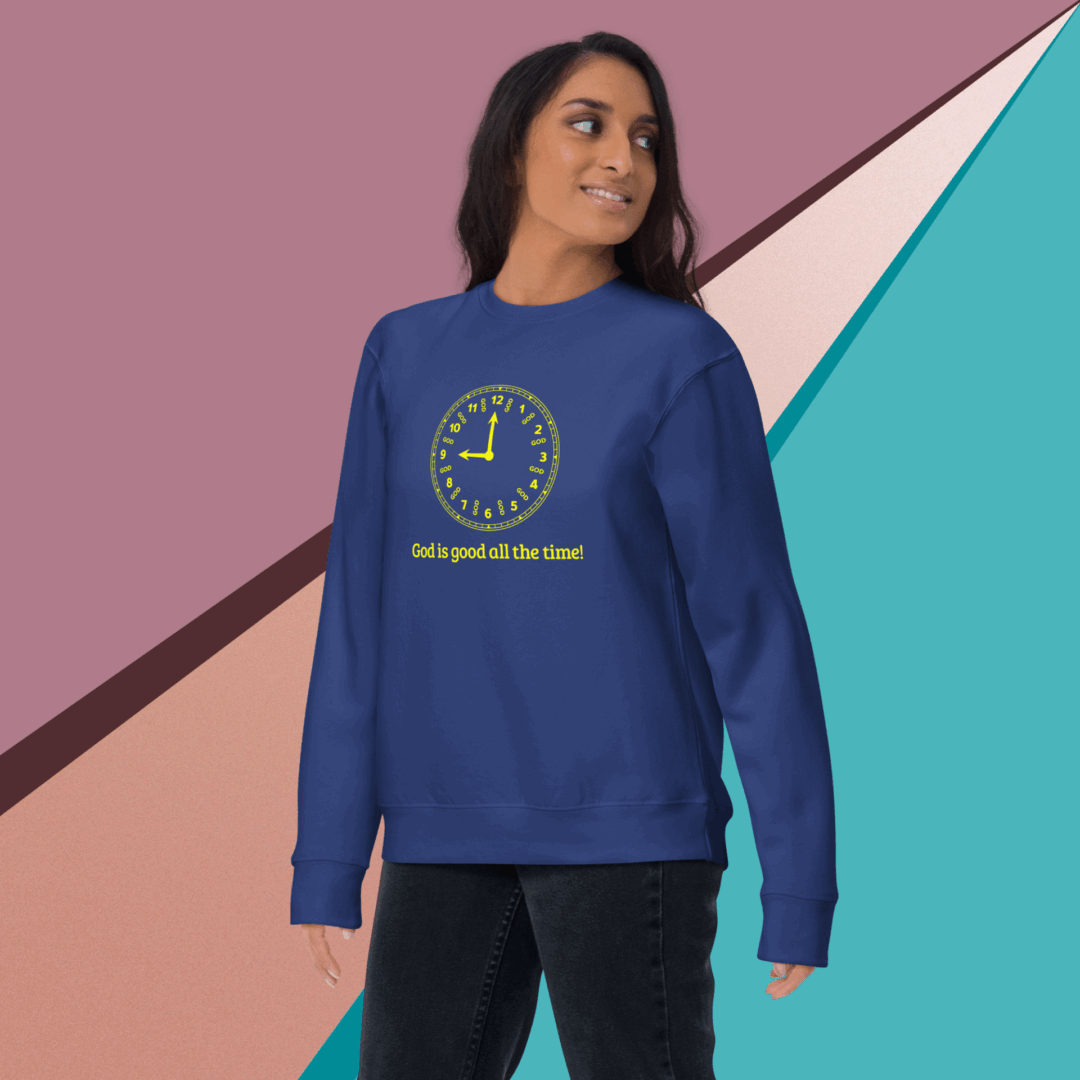 Woman wearing a blue sweatshirt with a yellow smiley face design.