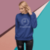 Woman wearing a blue sweatshirt with a clock and text design.