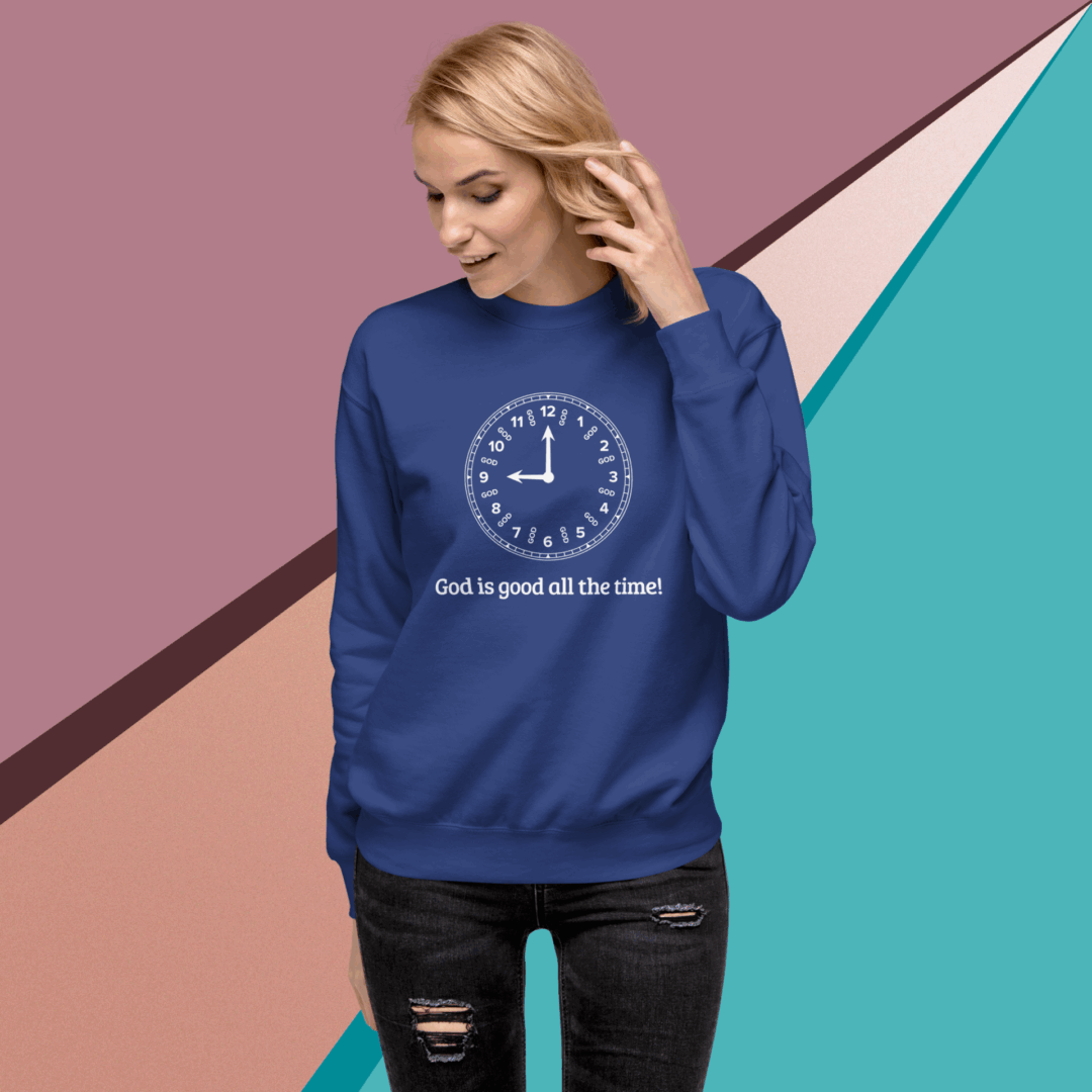 Woman wearing a blue sweatshirt with a clock and text design.