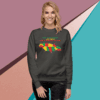 Woman wearing a colorful bear graphic sweatshirt with geometric shapes.