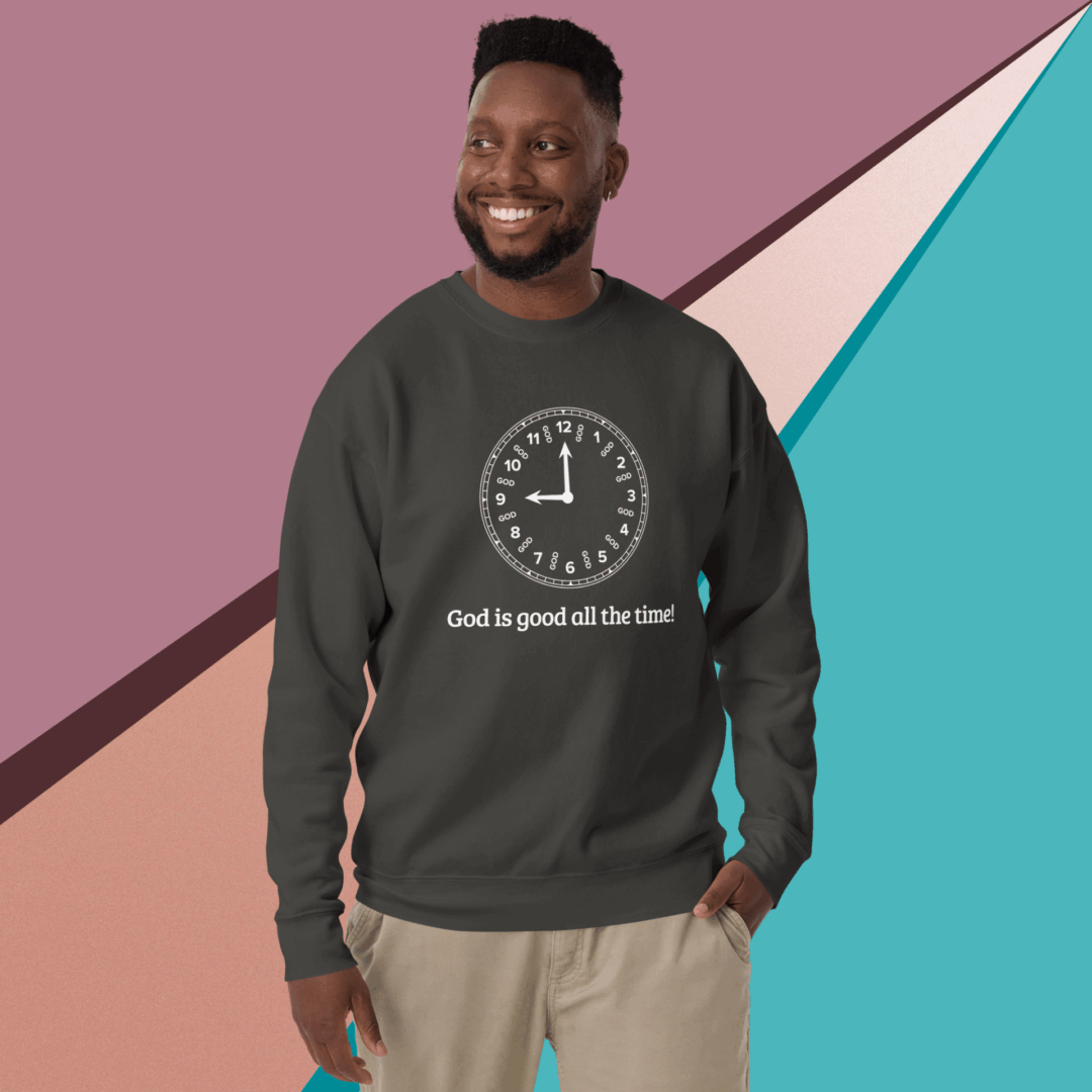 Smiling man wearing a dark sweatshirt with a clock and text design.