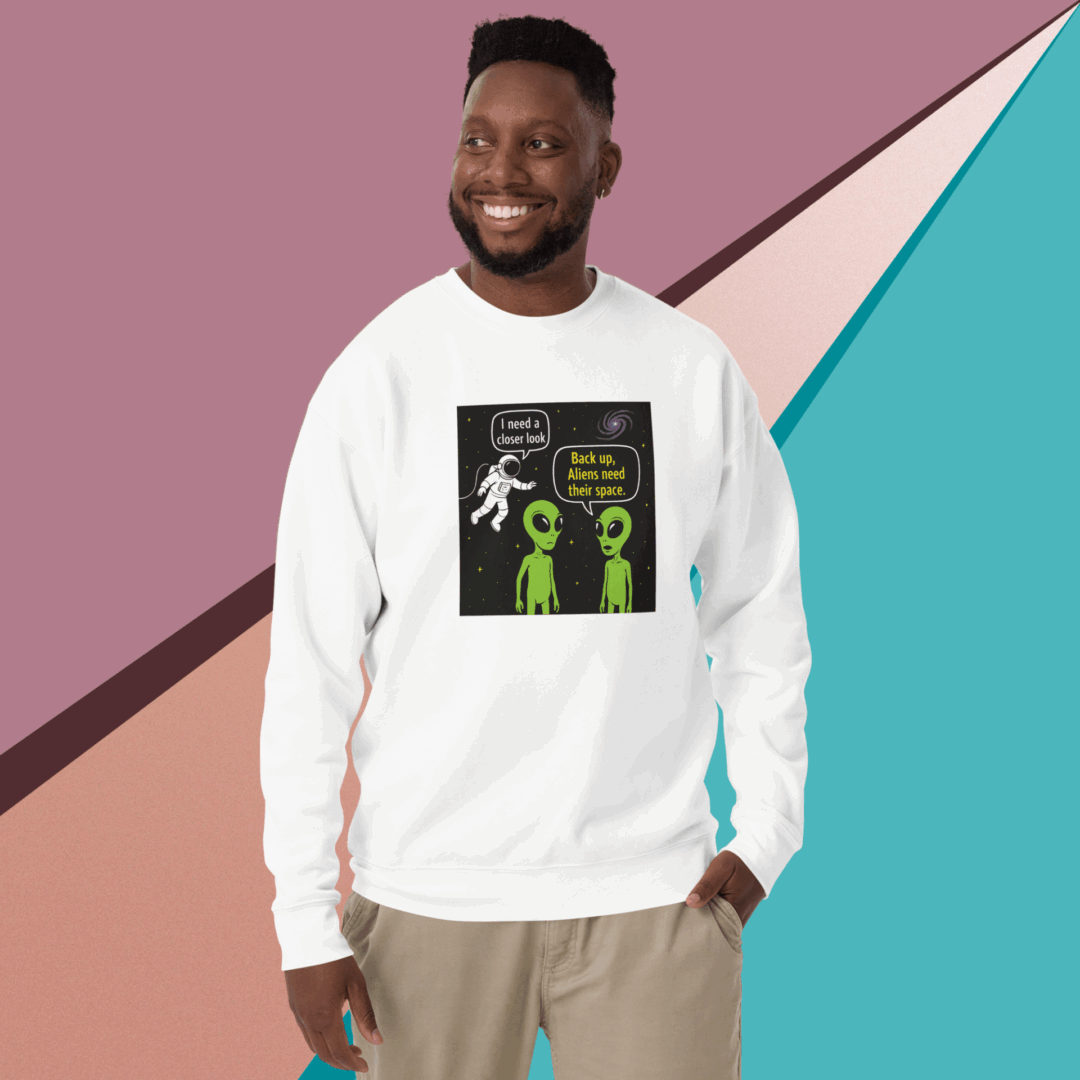 Smiling man wearing a white sweatshirt with science-themed graphics.