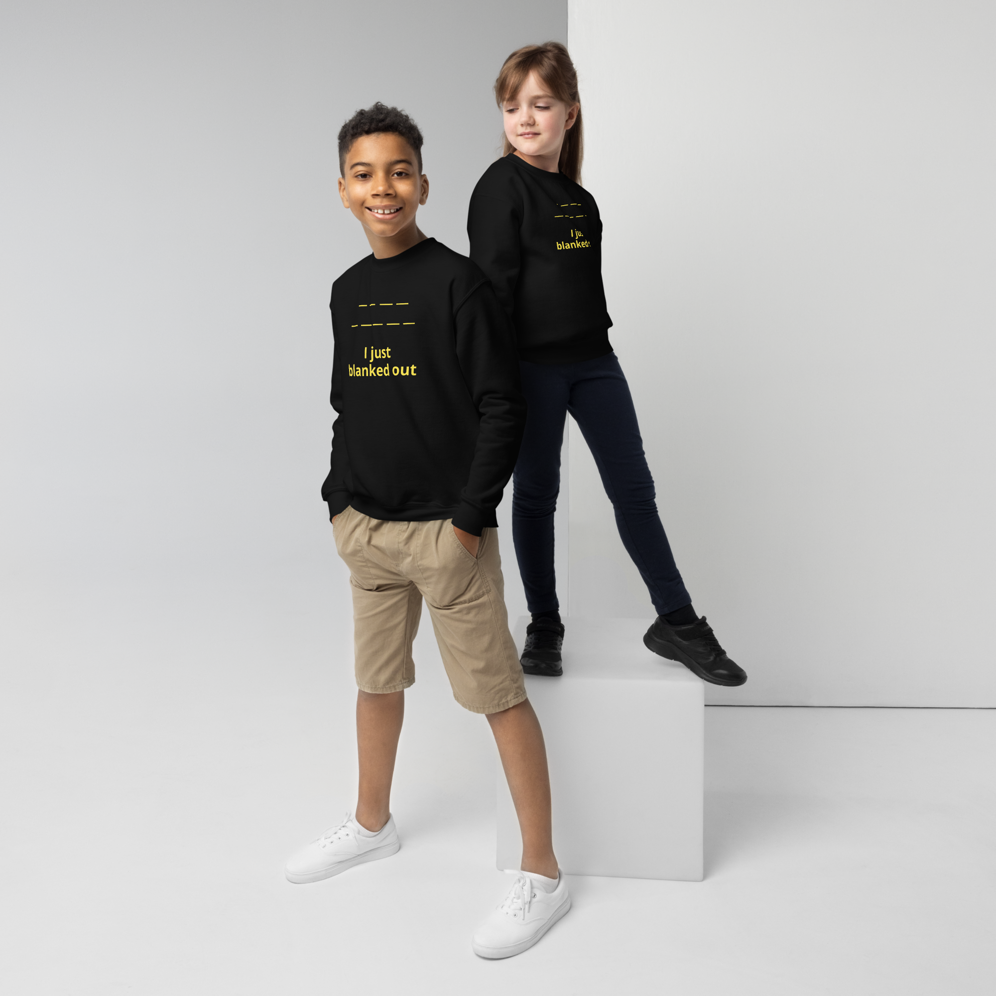 Two kids wearing black sweatshirts with "I just blanked out" in yellow text.