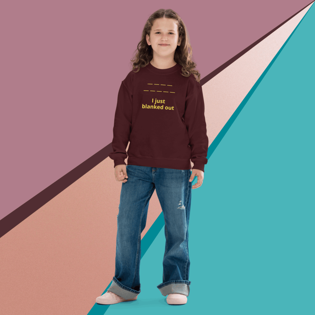 A woman stands confidently wearing a maroon sweater and blue jeans against a colorful abstract background.