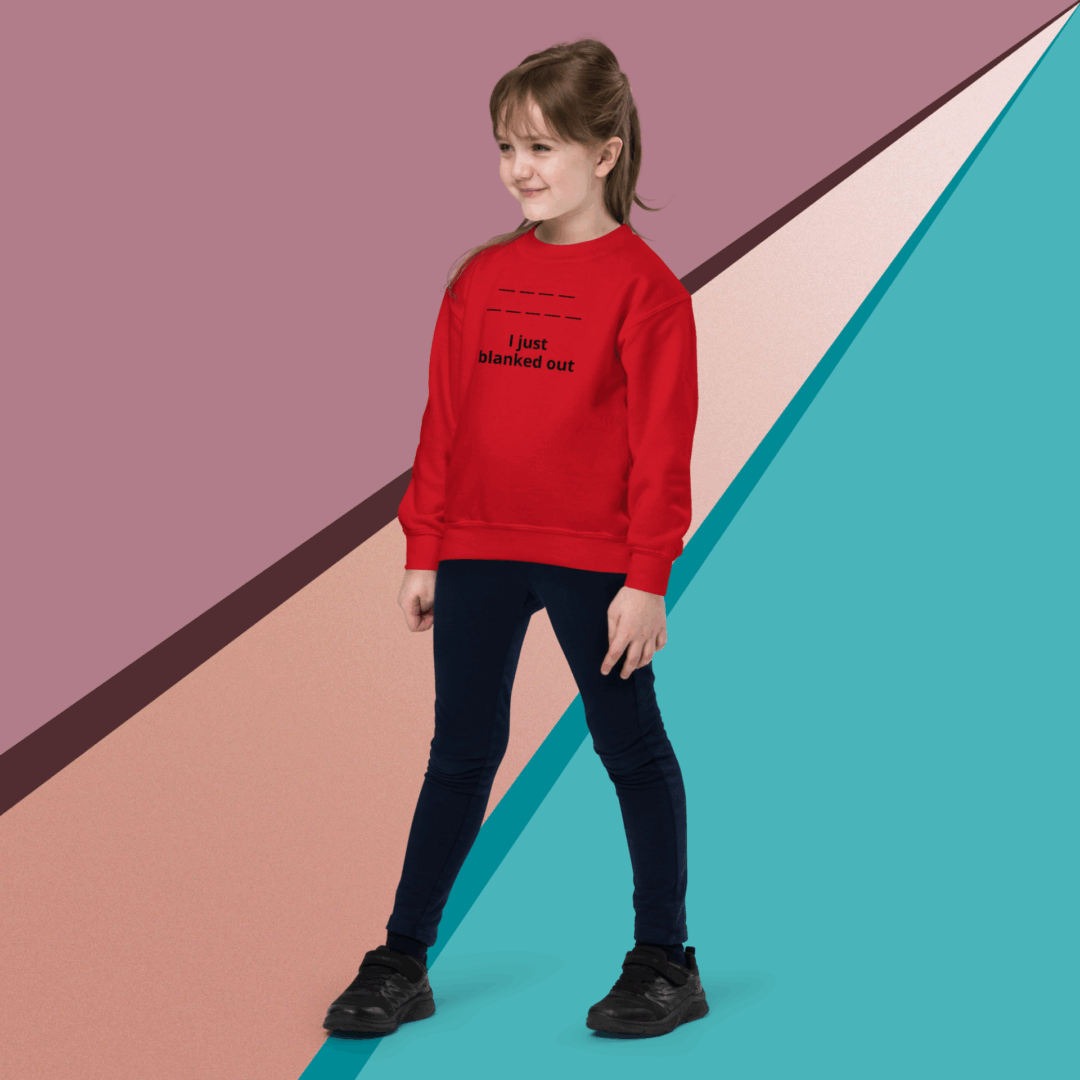 Young girl in a red sweater and black pants posing against a colorful geometric background.