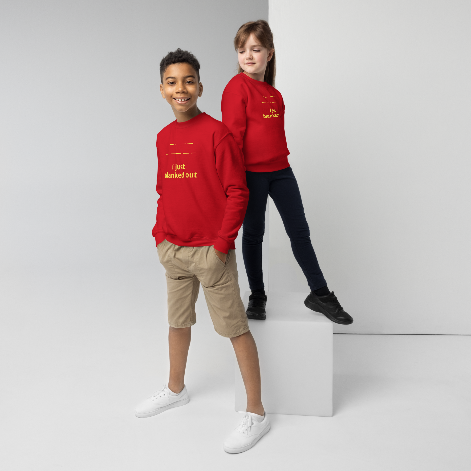 Two kids wearing red sweatshirts with "I just blanked out" text posing confidently.